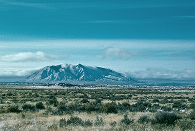 Winter on the INL. The mountain is the Big Southern Butte. Photo copyright Ralph Maughan